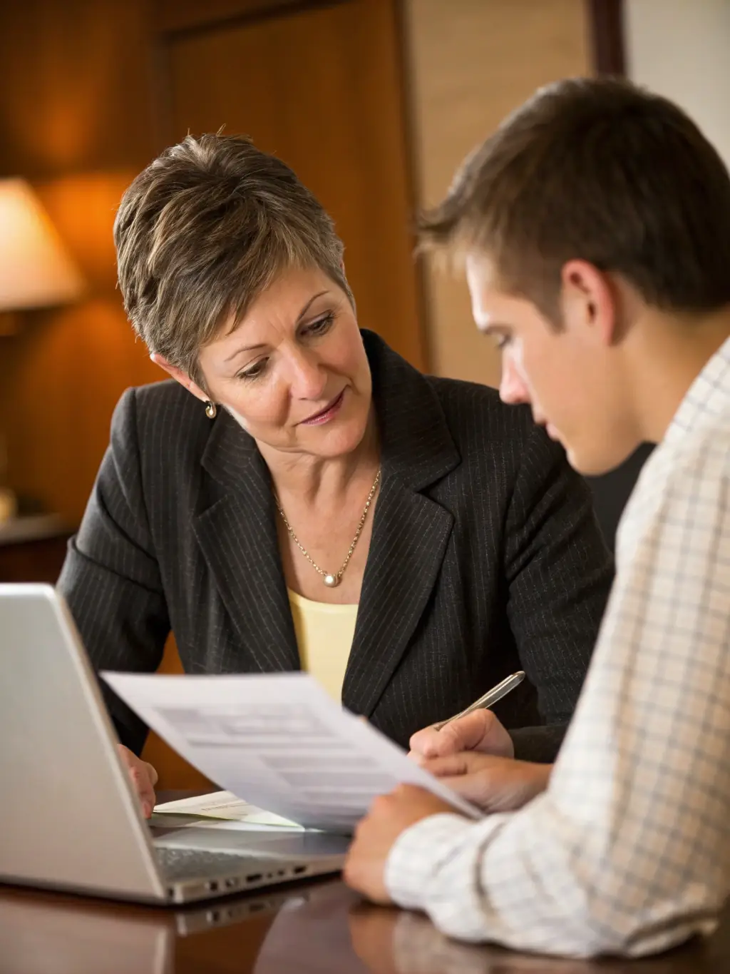 A business owner meeting with an Integral Insurance representative to discuss group health insurance options for their employees.